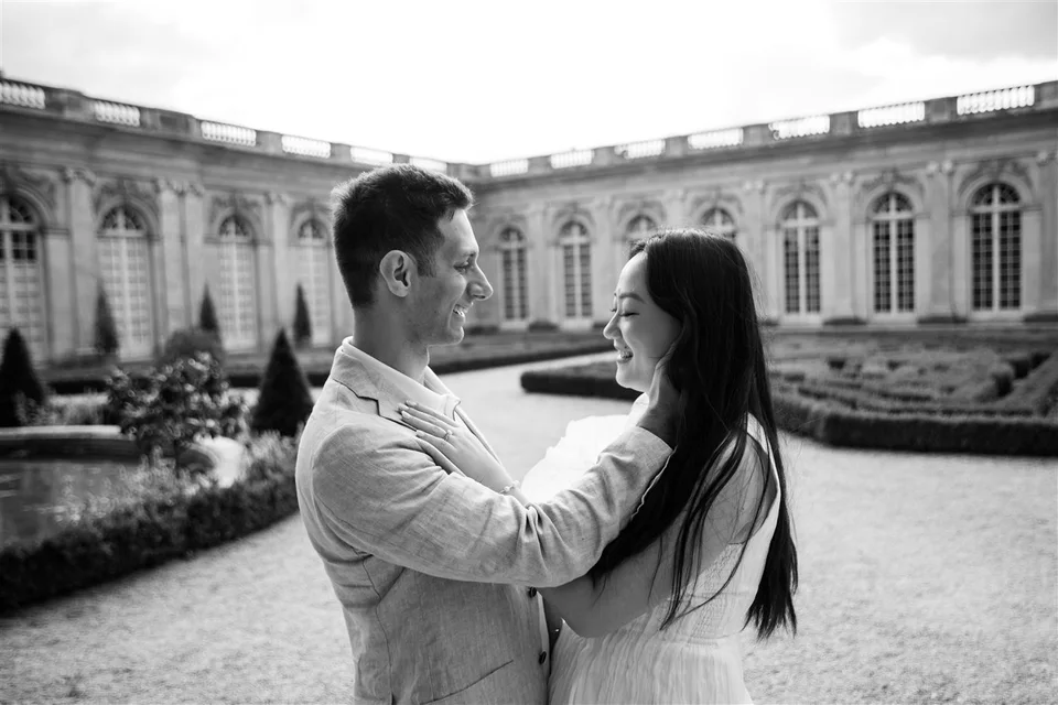 Alex and Yashi together in a garden, in black and white